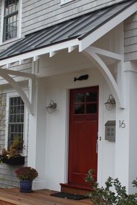 Porch with black metal roof / only big enough for seating and grill area   ...maybe cover the whole back of the house? yes!