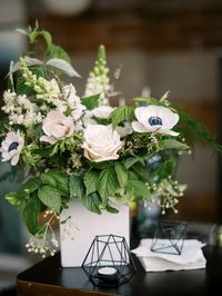 A beautiful summer garden bar floral arrangement with black and white anemones.