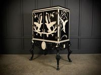 An unusual and impressive black lacquered drinks cabinet beautifully decorated with bone inlaid patterns and birds.

In very good condition, this cabinet has a fully mirrored interior with 2 glass shelves, there are a few small mosaic tiles with cracks.

The cabinet sits on a nicely carved ebonised base, with unusual shaped legs.

W 128cm/50.5"
D 84cm/33"
H 177cm/69.75"

Interior
W 104cm/41"
D 58cm/23"
H 88cm/54.75"