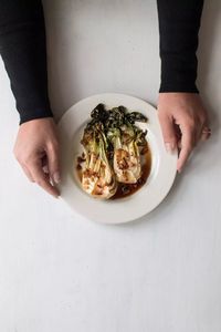 This delicious roasted baby bok choy is ready in just 10 minutes with garlic, ginger, soy sauce, and sesame seeds. Makes the perfect Asian side dish. #sidedish #quickandeasy #roastedvegetable #vegetablesidedish