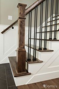 Staircase with white accents and black metal spindles and shoes