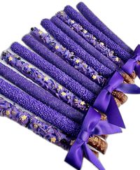 This listing is for 12 pretty purple pretzels. Each fresh pretzel rod is dipped in creamy purple chocolate and decorated with 3 different sprinkles: purple sugar, purple nonpareils and purple jimmies with gold stars. A perfect addition to a dessert table, a birthday party or shower. So beautiful that all the guests will want one.  Each favor will arrive to you individually wrapped in a clear cellophane sleeve and tied with color coordinating ribbons.  Delightful Chocolates cannot be held responsible for melted chocolate once the package has left our facility. We take great pride in insulating our boxes and packaging with ice sheets if needed PLEASE PURCHASE ICE SHEETS IF YOU LIVE IN A WARM CLIMATE. WE WILL NOT SHIP IF YOU ARE IN TEMPERATURES OF 65 DEGREES OR ABOVE  These confections were c