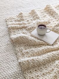 A chunky weight crochet blanket with a hot cup of tea.