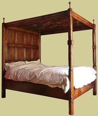 Tudor style oak 4-poster bed, with plain headboard panels with four carved parchemin panels to the tester ceiling. A bespoke simplified version of our lavishly carved four poster.