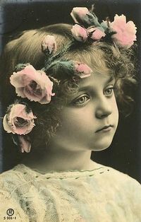 Beautiful little girl with crown of roses