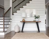 farmhouse interior white staircase with console table