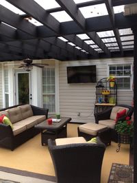 Don't really like the look/decor of this patio itself but the plexiglass on top of the pergola might be a good idea for our new house.