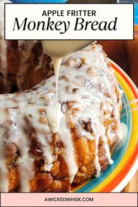 This Apple Fritter Monkey Bread is a gooey pull apart bread that is reminiscent of your favorite bakery apple fritters. Made withe refrigerated biscuit dough, this apple monkey bread is tender but with a crunchy crust, layered with apples, walnuts and cinnamon sugar then topped off with a vanilla icing drizzle sure to make this your favorite fall baking recipe! #applefritter #monkeybread #pullapartbread #fallbakingrecipe #applefrittermonkeybread #applebread