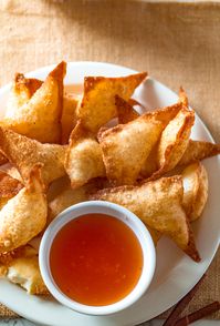 How to make traditionally sweet filled Crab Rangoons just like takeout! Skip the fast-food Restaurant and make these creamy crab dip pockets with cream cheese and imitation crab meat! This Crab Rangoon recipe is like the triangle pockets from American-Chinese Restaurants. Dip in a sweet and sour duck sauce and enjoy these deep-fried appetizers!  #Chinese #fastfoodrestaurant #alyonascooking #creamcheese #wontons #appetizer #cheesepuffs #dumplings #triangle #imitationcrab