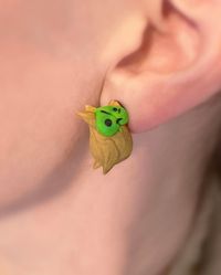 Super awesome accessory for any Zelda Breath of the Wild fan! This Korok earring set made of polymer clay are sure to get a double take. Korok earrings have the appearance of hanging on your ear. That is quite a drop maybe that's why these guys are holding on! :) different Korok on each ear! Standard posts are not hypoallergenic. If you have sensitive ears you can add on sterling silver or titanium  If you need another type of posts request a custom item, I can order and add them for you! These