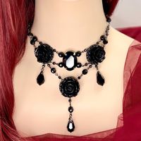 Dear customers, for a price offer of expedited shipping outside of Germany, please contact me directly via Etsy messages. A gothic elegant rose necklace with dangling emerald green & dark silver crystals , perfect for your gothic prom, wedding, black dress or even Halloween and cosplay costumes.  - Handmade jewelry - Original design  - Black & dark silver high quality Czech Fire polished beads  - Black high quality resin roses - Black high quality crystal pendant and droplets Sizes: - Necklace L