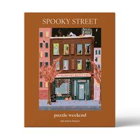 This 500 piece Halloween puzzle is a charming bookstore and coffee shop nestled in a vibrant autumn setting. Above the inviting storefront, the apartments are alive with spooky characters. All Sales Final.