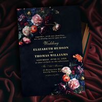 A gorgeous floral arrangement frames this stunning wedding invitation with a dark romantic theme. A dark navy background with black undertones is the canvas for classic typography and touches of elegant calligraphy in gold foil (real gold foil). A perfect choice for couples who love the dark romance wedding vibe and wedding stationery with a painting design, in the style of old Dutch masters. A dark and moody wedding invitation that infuses plenty of color and gives a wide range of color choices