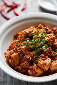 Spicy, flavorful, and satisfying, this plant-based Mapo Tofu includes a medley of ground mushrooms that give this Sichuan classic a meaty texture and flavor. #vegan #plantbased #veganrecipes #tofu