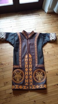 Viking-inspired leather caftan with appliqué work.