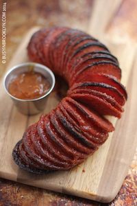 Drunken Hasselback Salami - accordion-sliced baked salami with an apricot brandy sauce