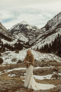 Laid Back Mountain Elopement in Winter | Taya and Becky's private mountain elopement vows were followed with a pizza elopement picnic and more dreamy, snowy wedding photos. See more winter wedding aesthetic, lace wedding dress, mountain elopement wedding and elopement wedding lgbt. Book McKenzie for your Colorado elopement and alternative wedding photography at mckenziebigliazzi.com!