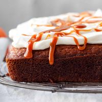 This Pumpkin Cake is my absolute favorite fall dessert. The cake is moist and topped with a fluffy whipped cream cheese and drizzled with caramel sauce. It the perfect pumpkin cake for cozy autumn days.