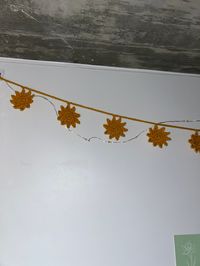 Handmade crochet sun garland, pastel yellow, 10 suns, ~60 inches long