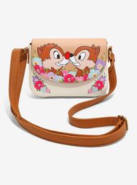 Rep the ultimate Disney duo with this crossbody bag inspired by Chip 'N' Dale! It shows the bestie chipmunks nose to nose on the front flap  surrounded by flowers. The bag has a magnetic closure and an adjustable strap.