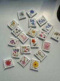 Hand made stamp magnets made out of clay. You'll receive an assortment of 4 stamps. The current designs are florals, strawberries, pink, blue, and wineglasses. These are the size of a real life stamp, about 1.25"