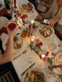 Candlit friendsgiving dinner party in Charleston, SC. Painted names on the tablecloth