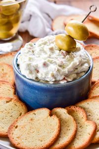 Say hello to your new favorite appetizer! This Dirty Martini Dip has all the flavors of the classic cocktail in a creamy dip that's packed with the flavors of blue cheese and olives. Perfect for dipping pretzels, crackers, or any of your favorite dippers!