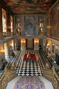 The painted hall. Chatsworth House is a stately home in North Derbyshire, England, 3.5 miles (5.6 km) northeast of Bakewell and 9 miles (14 km) west of Chesterfield. It is the seat of the Duke of Devonshire, and has been home to his family, the Cavendish family, since Bess of Hardwick settled at Chatsworth in 1549. Standing on the east bank of the River Derwent, Chatsworth looks across to the low hills that divide the Derwent and Wye valleys. The house is set in expansive parkland, and back...