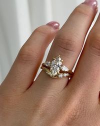 The Moissanite Company - Moissanite & Lab Diamonds on Instagram: "We are lost in the sheer perfection of these bridal stacks ✨ Our Eve Ring boasts an organically curved band adorned with three intricately placed accent stones. ⁠ ⁠ SWIPE to explore how we have created an array of luxurious rings stacks, each showcasing the Eve Ring... ⁠"