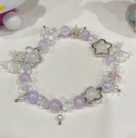 Clear and purple beaded bracelet with charms that's stretchy