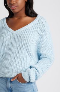 Fall for the slouchy fit of this drop-shoulder sweater that reverses from a scoop neck to a V-neck. 20" length (size Medium) Scoop neck or V-neck Long sleeves 60% cotton, 40% acrylic Machine wash, dry flat Imported Not available for sale and shipment to Germany