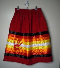 Beautiful red flannel fabric with Fire Colored Ribbon, and a red hand print meant to honor Missing and Murdered indigenous relatives. This skirt can be made to fit any size, but price may vary depending on size. (Children sizes will be less) Includes pockets! Please message if you have any questions. Minimum length is 28", due to the ribbon width and pockets. The red ribbon color may vary slightly due to dark red ribbon shortages. Processing is 1-3 weeks, but you can message me if you need it sooner.