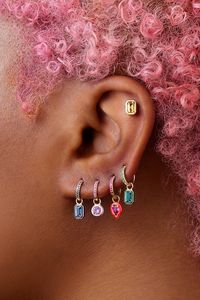 An easy way to add a touch of color to your ear. Our signature emerald huggie features pavé emeralds on the front side. We love how they look layered in multiple piercings. Wear alone or mix and match with our other huggie charms.