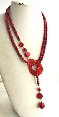 Fascinating and very flexible for the different ways of wearing it, this beautiful long (or short and doubled) necklace, made with hand-engraved bamboo coral and red jade pearls. Cm. 120 absolutely U N I C piece!