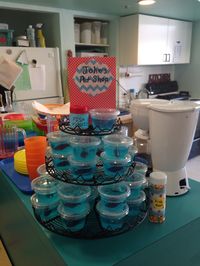 Mini jello aquariums. Blue jello Swedish fish bowls with Nerd candy "fish food".  Pictured here at my son's preschool. Wish I thought to get a pic at home with a more attractive background and better light.   The key here is to dilute blue jello; otherwise it will be too blue to see through. I used ratio of 1/2 blue jello (per instructions on box ) and 1/2 sprite with plain gelatin  (per instructions on box). Insert fish shortly before serving (otherwise they turn to mush) by first cutting slit