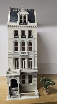 The Grosvenor Gardens it is an miniature replica of an existing building on Grosvenor Gardens , London, UK . A lovely Victorian building with an Mansarde roof.  Detachable front  for easy access. A miniature house kit in a 1:48 scale is like a tiny, tiny version of a real Victorian house from a long time ago. It's so small....but when you put it together, it looks just like a real house, with all those fancy details like windows, doors, and a roof. Imagine it comes in a flat pack, like a puzzle