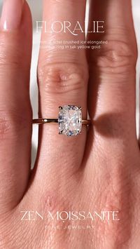 Floralie engagement ring has a solitaire design, 4 claw prongs, a flower basket and a 1.7mm plain gold band, set with a center 9x7mm (2.4cte) crushed ice elongated cushion moissanite gemstone.✨  Zen Moissanite jewelry pieces are custom made, ethical and durable Diamond alternatives.✨