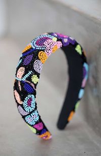 The L. Erickson Tori Padded Headband is a cheerful, beaded headband, prefect for the warmer days. This headband features colorful flowers across a wide beaded band. Perfect for any hair type, this wide headband is suitable for many occasions. For an easy hairstyle, add this headband to your outfit on your way to the beach or the store. Product Features:- Imported by L. Erickson- Great for most hair types- Comfortable, easy hair style solution- Large, wide band- Made of polyester, beaded- Dimensi