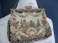 "Vintage tapestry handbag made in France featuring a lovely forest and castle fairy tale scene with a goldtone filigree clasp and on a short simple chain. No tag indicating brand or maker. Some light wear on due to age - one small yellowing spot as seen in picture 7, and the inside lining has some discoloring but is still intact and in great condition to be used for many more years. 7.5\"x5.75\"."