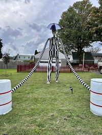 Outdoor fabric, the arms are black coated dryer vent hose with white duct tape for the stripes, and the barrels are painted 55 gallon plastic drums