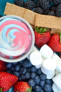 This 4th of July Fruit Dip is the perfect dish to enjoy on a hot summer day. The red white and blue fruit dip takes a creamy, sweet fruit dip and turns it into the perfect patriotic dessert. Pair the dip with an array of red and blue berries and marshmallows to create a delicious and refreshing summer dessert. No need to heat up your home to make this summer treat - this no bake dessert is perfect to bring to any 4th of July or Memorial Day party. #4thofjuly #memorialday #fruitdip