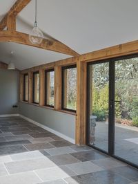 These aluminium doors were set in timber frames on a barn renovation. The traditional barn was updated to modern home with the use of aluminium doors set within timber frames. This image shows the hallway of the barn renovation with the aluminium doors in timber frames lining the walkway. Aluminium frames can be installed in timber frames if designed and engineered properly as IQ did on this project. Click on the image to find out more about this project using aluminium doors in timber frames.