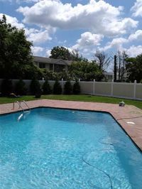 Two-tone 72″ Infinity Solid vinyl PVC pool safety fence. Tan panels and white frame. Fabricated and installed by Liberty Fence & Railing. Double virgin vinyl.