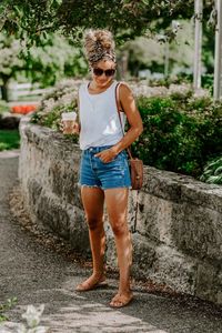 This white tank top is perfect for summer! It's breathable and boxy (which is great for bacne) while being comfortable at the same time. Not only that, but it's not see through! Dress this summer tank top up or down and you'll get lots of wear out of it this summer. Plus, it's only $10! #summeroutfit #summerfashion #denimshortsoutfit