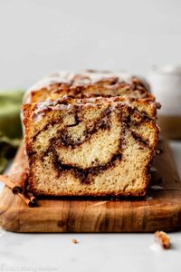 Deliciously moist and soft quick bread with an extra thick cinnamon swirl layer inside, crunchy cinnamon sugar topping, and vanilla icing. Recipe on sallysbakingaddiction.com