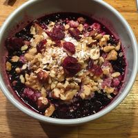 Oatmeal with warm blue berries, nuts and tried cranberries