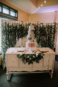 Vintage credenza in a chippy white chalk paint perfect for a dessert + cake table at your vintage inspired wedding or event. Book your vintage furniture + decor rentals at Orange Trunk Vintage in Calgary, Alberta.