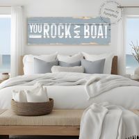 This custom canvas You Rock My Boat sign displays art that looks like wood with gentle grain and plank lines (but the canvas has a flat face). The canvas art is available in rustic or solid edges. The rustic edges option displays exposed natural wood art as if worn away by the elements, providing a wonderfully warm finishing accent to your home. The solid edges option provides a more refined and contemporary finish. Both options feature details like a wooden sign but with all the advantages of a