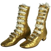 Exceptional and rare French Art Deco Gold Kid Boots. Of fine gold kid leather with high multi strapped instep closed with Tiffany style art glass iridescent shoe buttons. Sole stamped "Franks", which was a fine importer in the period. Excellent Condition overall. High 9" Length 9" heel -Toe Instep 6.50"