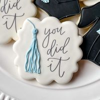 A classic for any graduate! This decorated cookie set includes "You Did It!" plaque cookies, graduation gown cookies and graduation cap cookies. In the box provided, please list the color that you would like to see on the tassels.